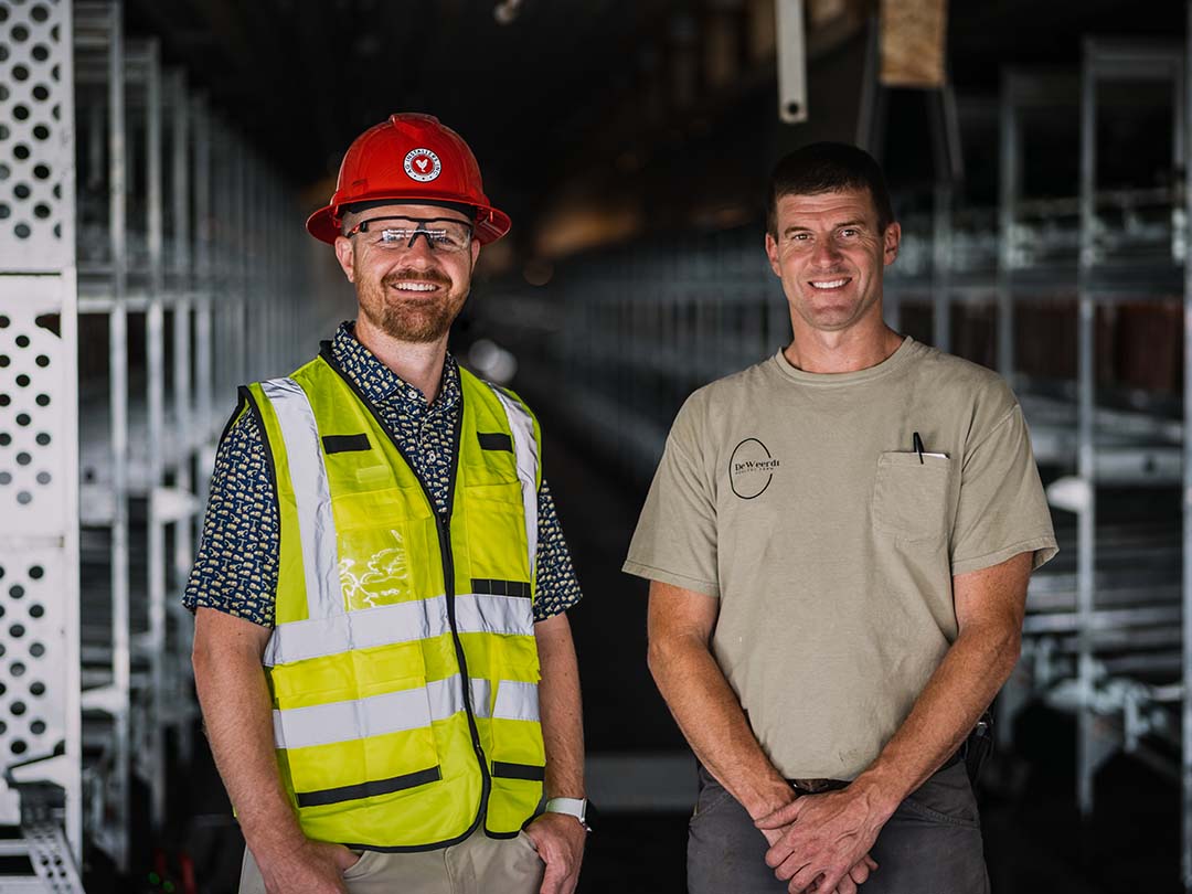 AG Installers employee standing next to client on worksite